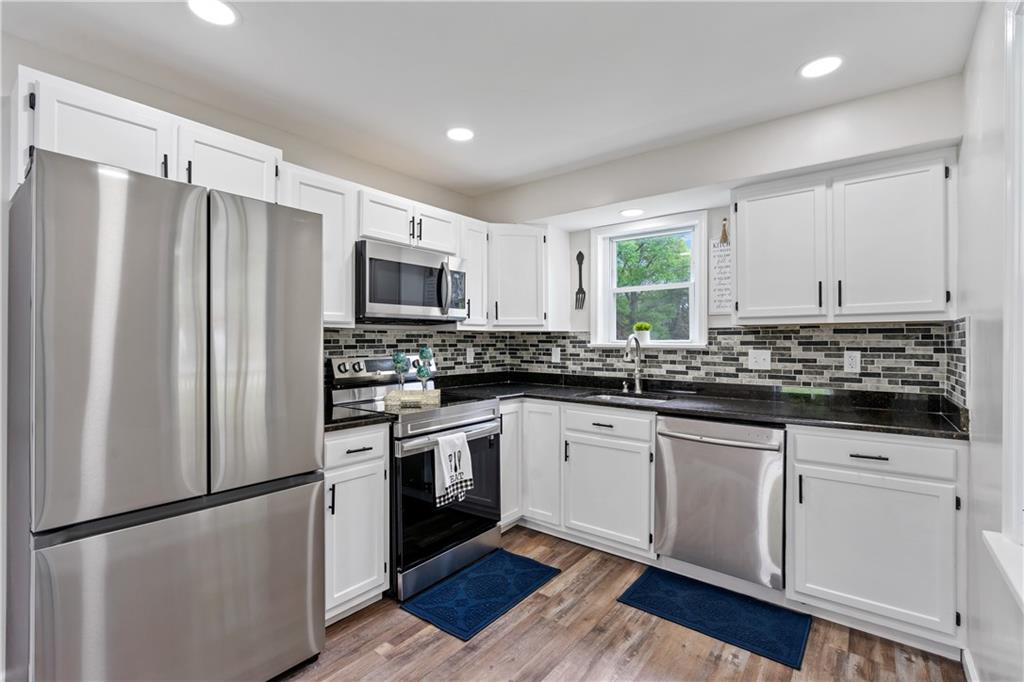 951 Shenango Road Beaver Falls, PA 15010 - Photo 3 of 25 a kitchen with granite countertop a refrigerator sink and microwave