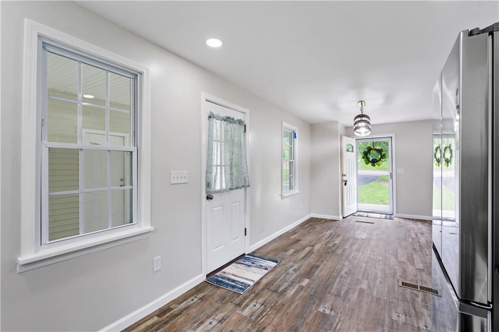 951 Shenango Road Beaver Falls, PA 15010 - Photo 5 of 25 a view of an empty room with window and wooden floor