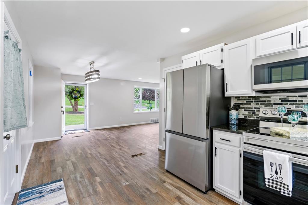 951 Shenango Road Beaver Falls, PA 15010 - Photo 6 of 25 a kitchen with granite countertop a refrigerator and a stove top oven