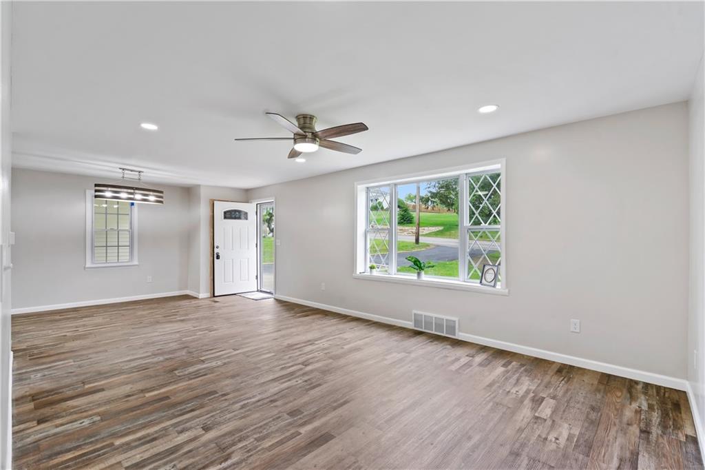 951 Shenango Road Beaver Falls, PA 15010 - Photo 9 of 25 a view of an empty room with wooden floor and a window