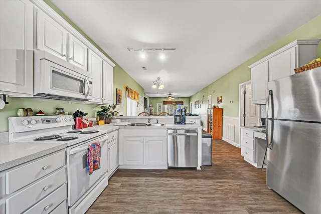 a kitchen with cabinets and stainless steel appliances