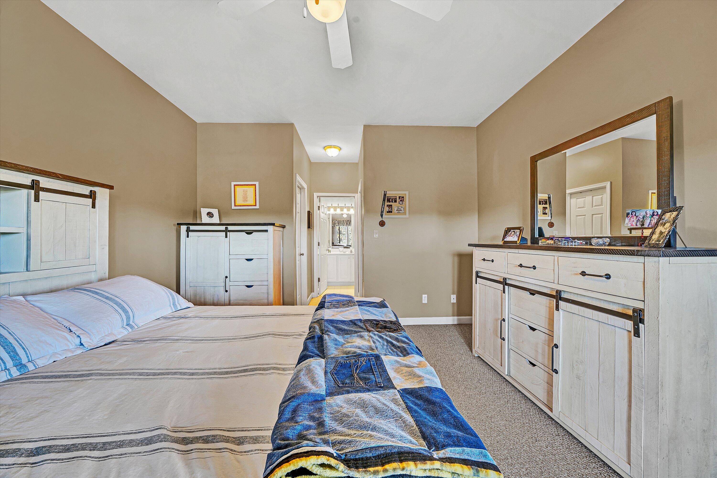 1103 Mariners Way, Unit 1 Huddleston, VA 24104 - Photo 19 of 27 a bedroom with a bed and dresser with mirror