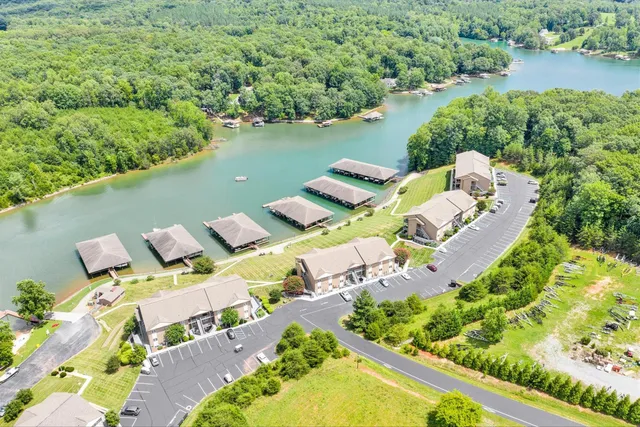 an aerial view of a house with outdoor space and lake view