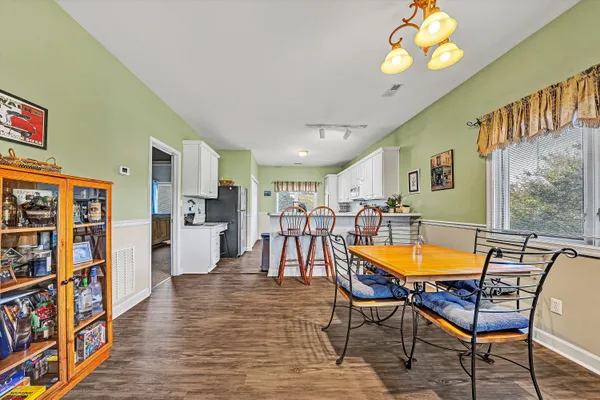 a dining room with furniture and wooden floor