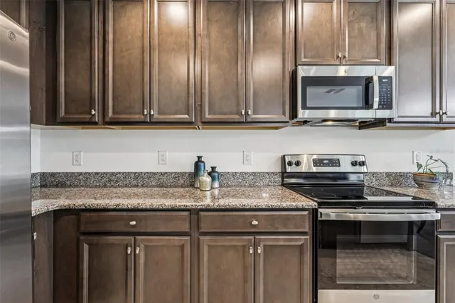 a kitchen with granite countertop a stove and a sink