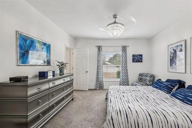 a bedroom with a bed and a chandelier