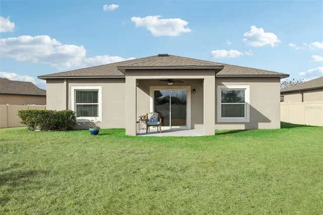 a view of a house with a backyard