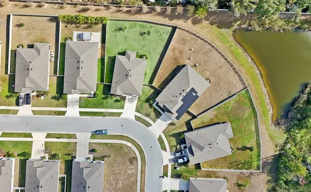 an aerial view of a house with a swimming pool