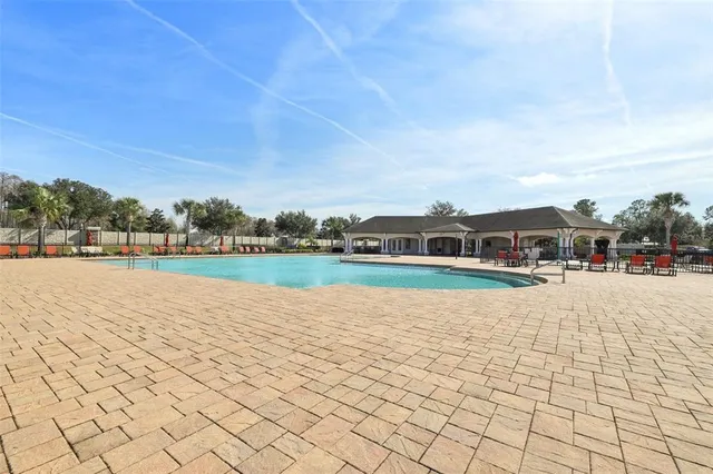 a view of swimming pool and trees in the background