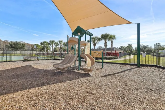 a view of outdoor space with playground and green space