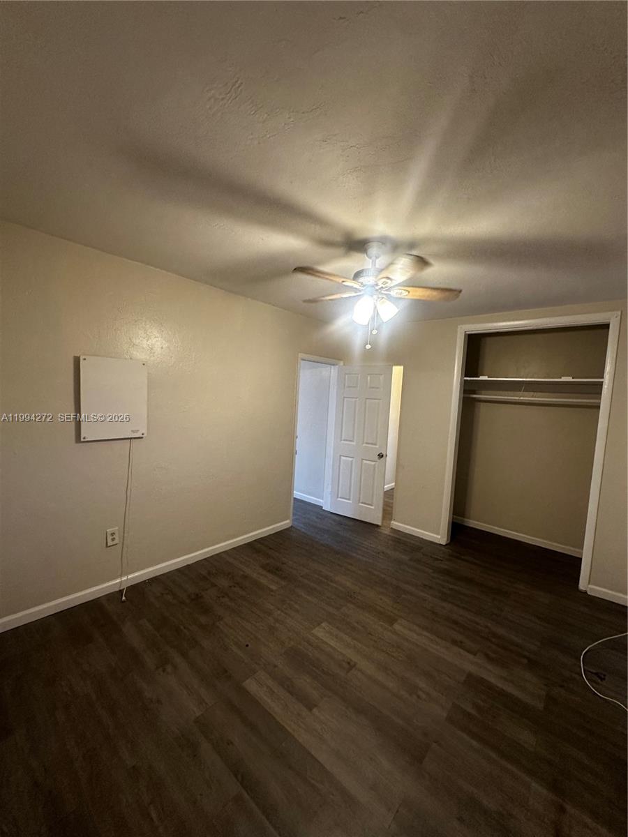 112 Northeast 63rd Street, Unit 112 Miami, FL 33138 - Photo 12 of 18 an empty room with wooden floor and windows