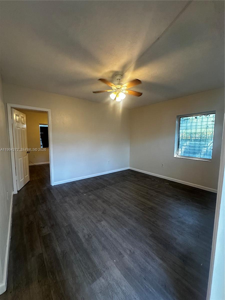 112 Northeast 63rd Street, Unit 112 Miami, FL 33138 - Photo 4 of 18 a view of an empty room with wooden floor and a window