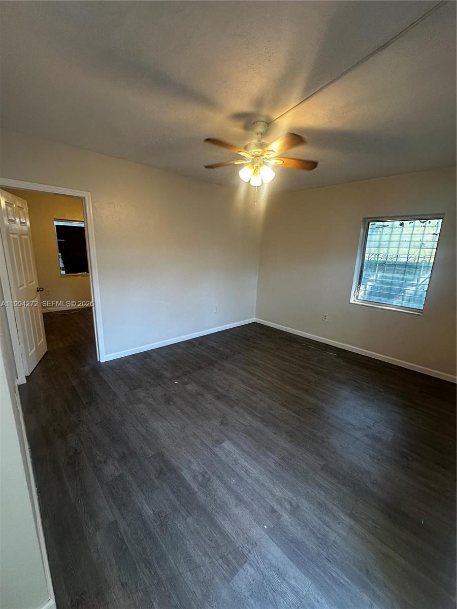 112 Northeast 63rd Street, Unit 112 Miami, FL 33138 - Photo 9 of 18 a view of empty room with wooden floor and fan