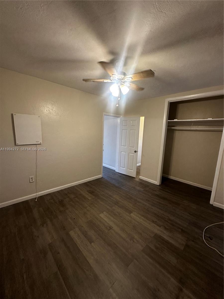 112 Northeast 63rd Street, Unit 112 Miami, FL 33138 - Photo 10 of 18 an empty room with wooden floor and fan
