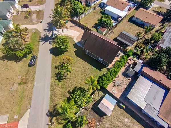 an aerial view of a house with a yard