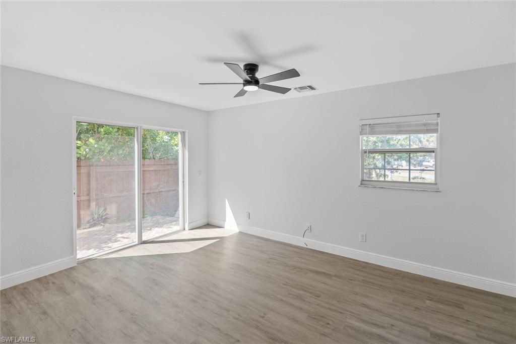 Undisclosed Address Naples, FL 34113 - Photo 12 of 21 an empty room with wooden floor fan and windows