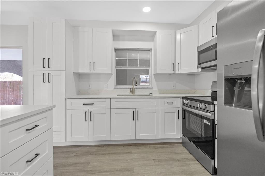 Undisclosed Address Naples, FL 34113 - Photo 14 of 21 a kitchen with stainless steel appliances granite countertop a sink and cabinets