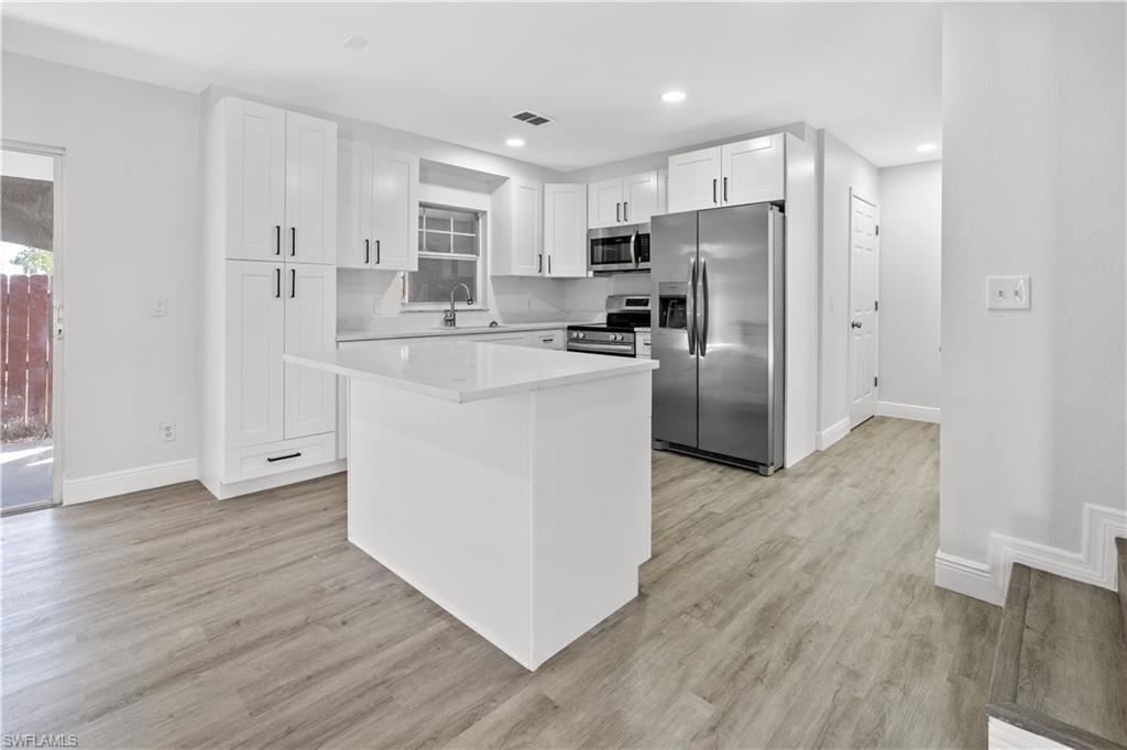 Undisclosed Address Naples, FL 34113 - Photo 15 of 21 a kitchen with stainless steel appliances a refrigerator and a stove top oven