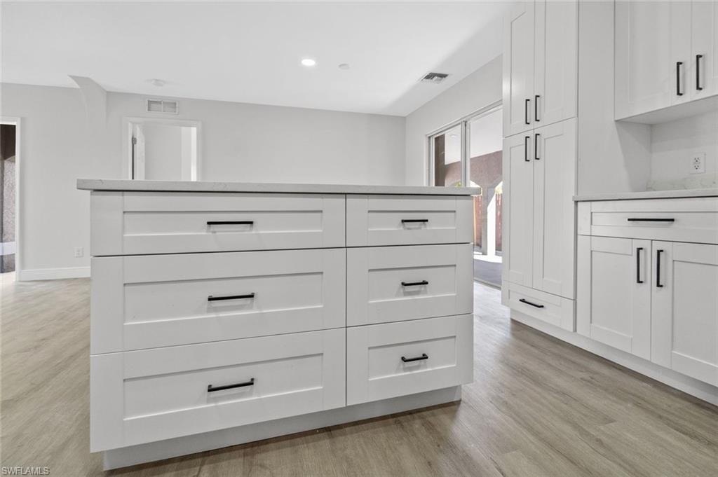 Undisclosed Address Naples, FL 34113 - Photo 16 of 21 a kitchen with white cabinets and a refrigerator