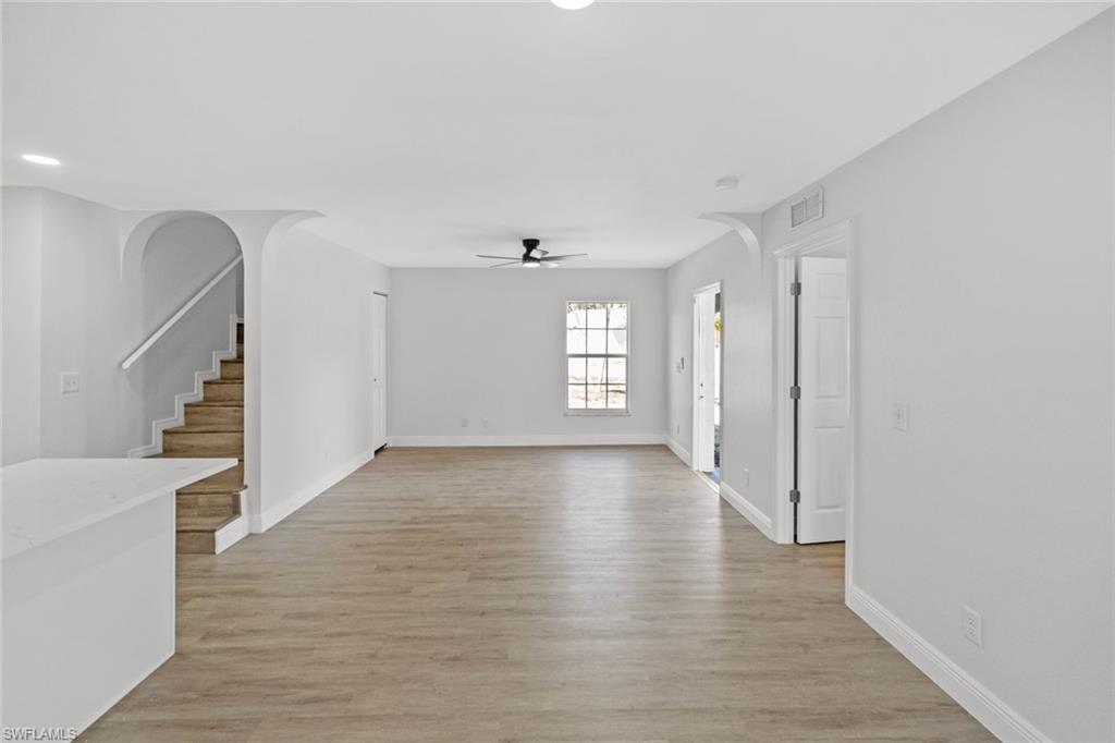 Undisclosed Address Naples, FL 34113 - Photo 17 of 21 a view of an empty room with wooden floor and a window