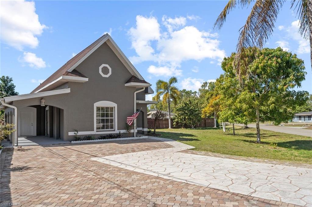Undisclosed Address Naples, FL 34113 - Photo 19 of 21 a front view of a house with a yard