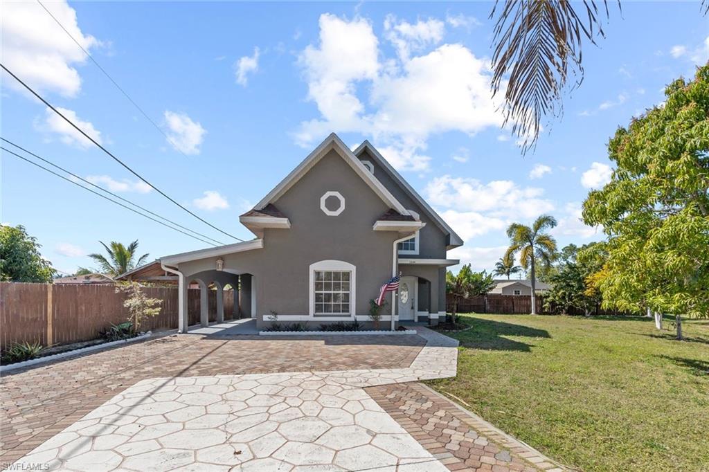 Undisclosed Address Naples, FL 34113 - Photo 21 of 21 a front view of a house with a yard