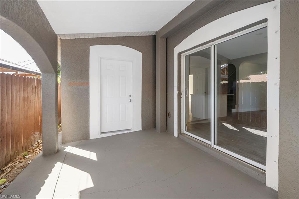 Undisclosed Address Naples, FL 34113 - Photo 4 of 21 an empty room with sliding door and mirror