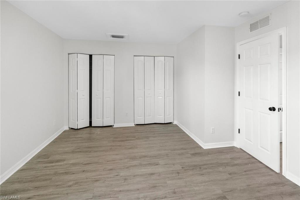 Undisclosed Address Naples, FL 34113 - Photo 5 of 21 a view of an empty room with wooden floor