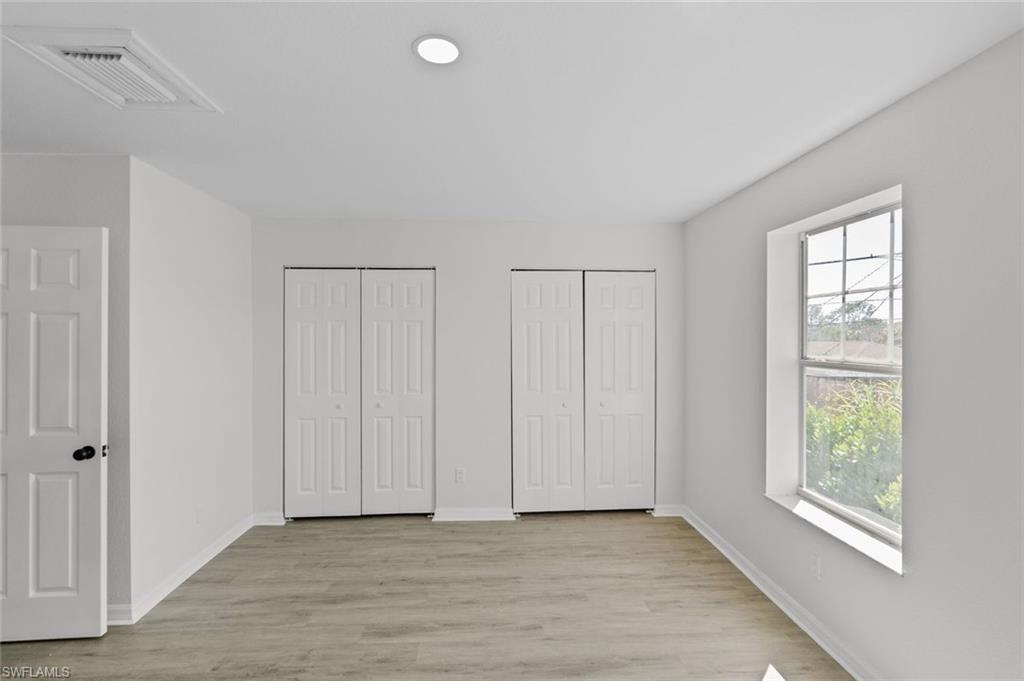 Undisclosed Address Naples, FL 34113 - Photo 9 of 21 an empty room with windows