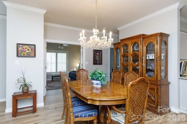 a view of a dining room with furniture and chandelier