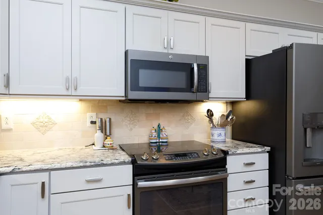a kitchen with granite countertop cabinets and steel stainless steel appliances