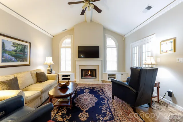 a living room with furniture fireplace and window