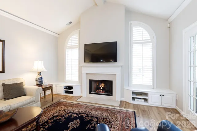 a living room with furniture fireplace and window