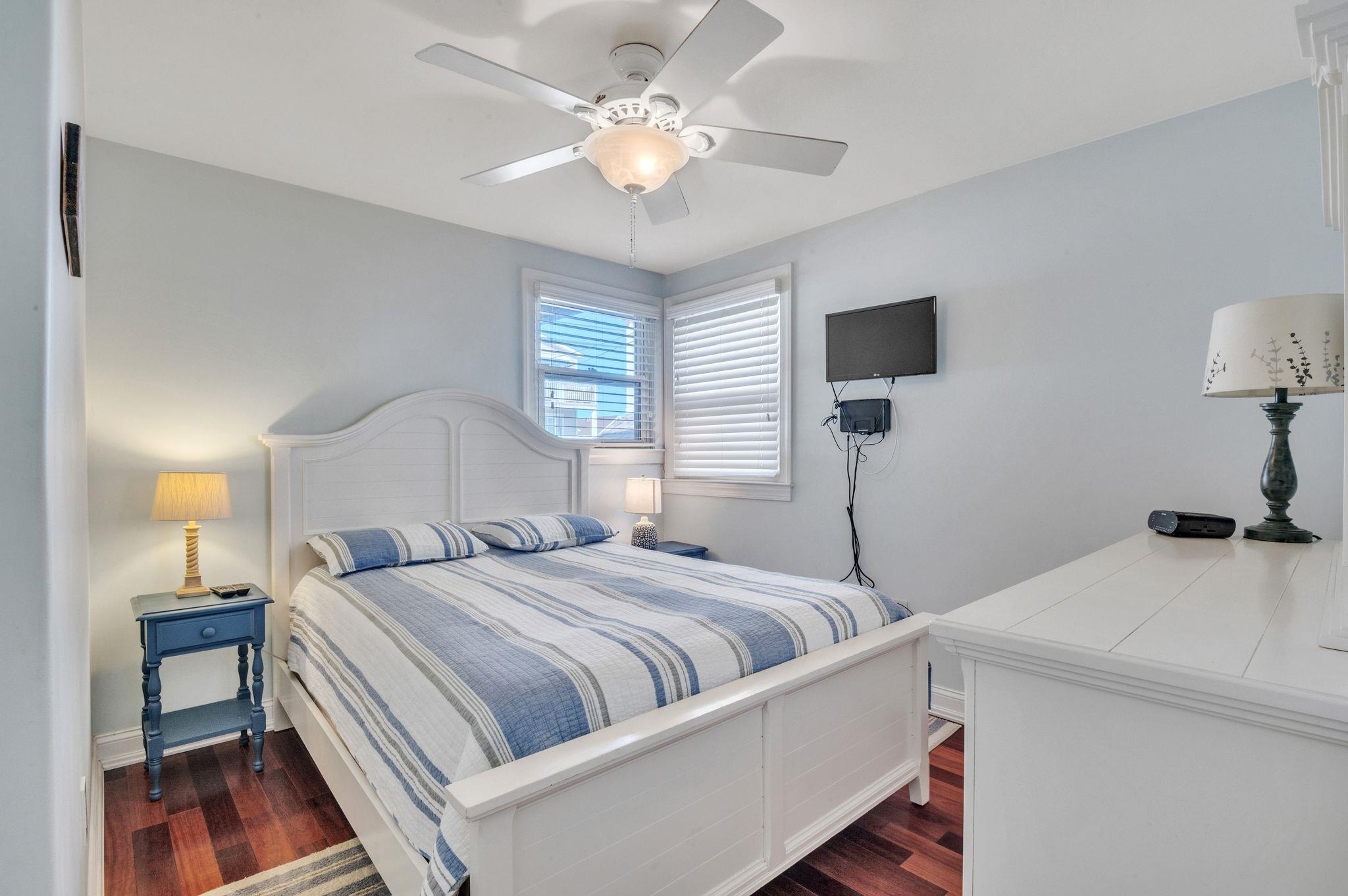 1504 Central, Unit 1504 Ocean City, NJ 08330 - Photo 12 of 16 a bedroom with a bed and a chandelier