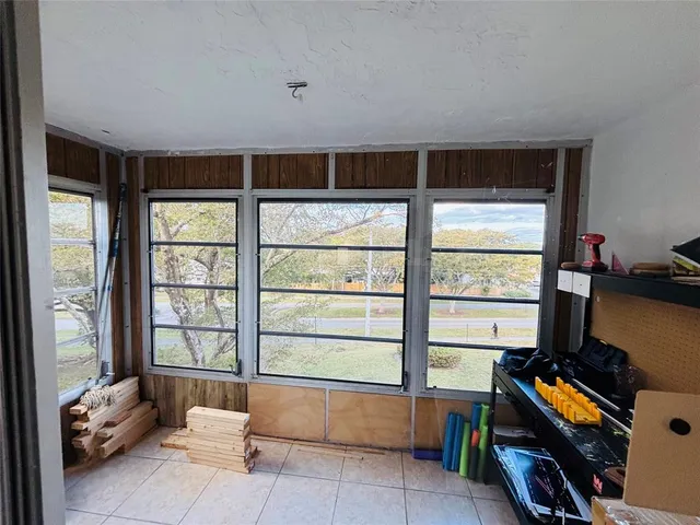 a view of a hallway with closet and a bathroom