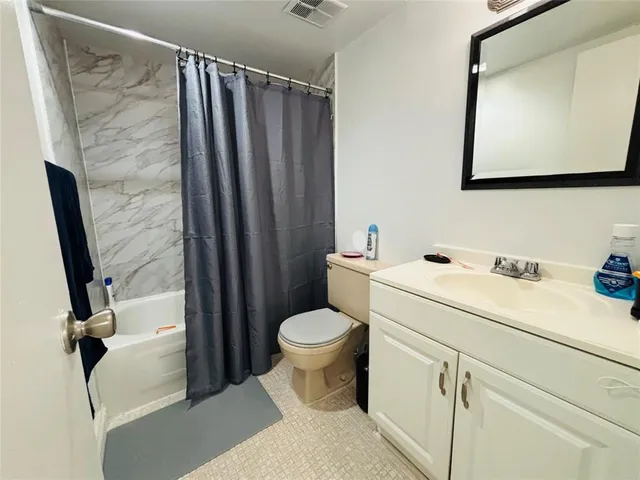 a bedroom with a bed and cabinets