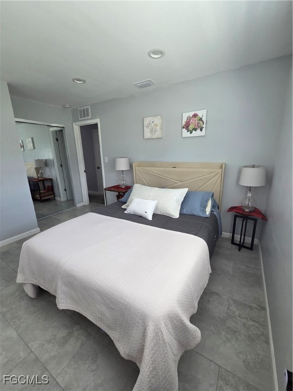 8141 Cleaves Road North Fort Myers, FL 33903 - Photo 18 of 37 a bedroom with a bed and chair