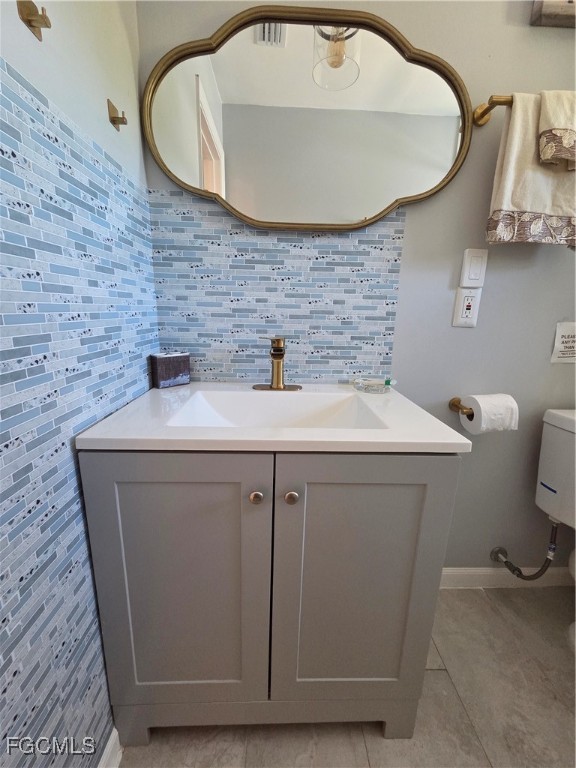 8141 Cleaves Road North Fort Myers, FL 33903 - Photo 19 of 37 a bathroom with a sink a toilet and mirror