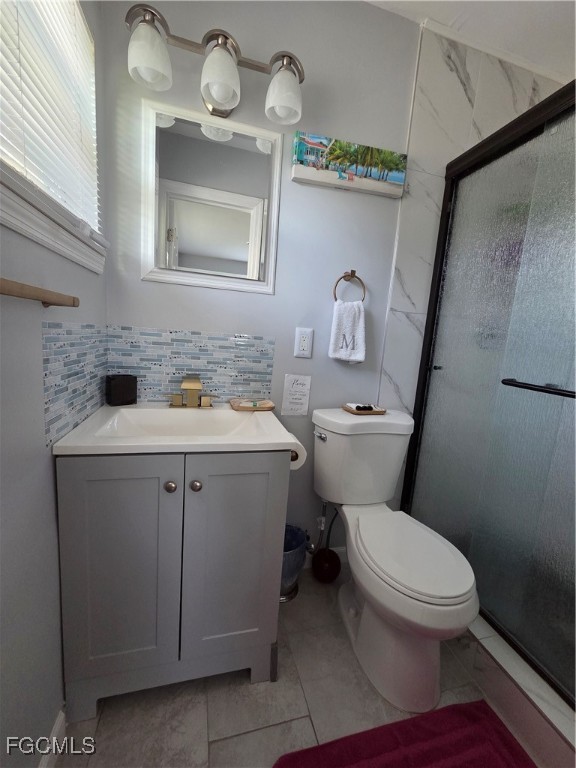 8141 Cleaves Road North Fort Myers, FL 33903 - Photo 22 of 37 a bathroom with a toilet sink and mirror