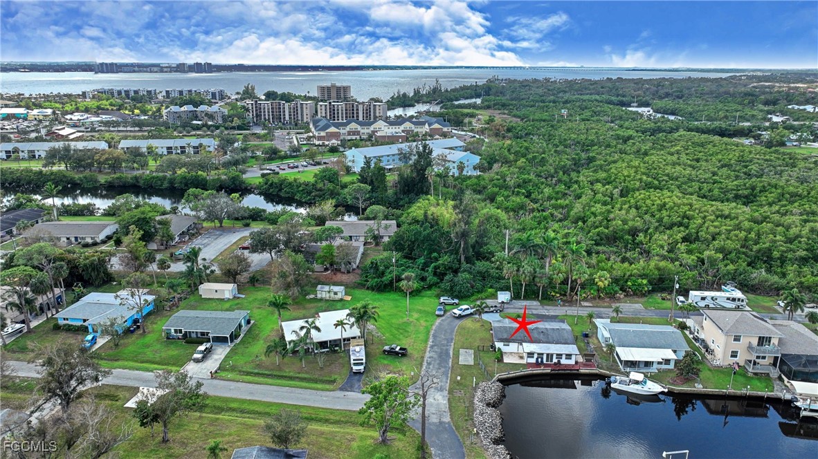 8141 Cleaves Road North Fort Myers, FL 33903 - Photo 31 of 37 an aerial view of a city with lots of residential buildings ocean and mountain view in back