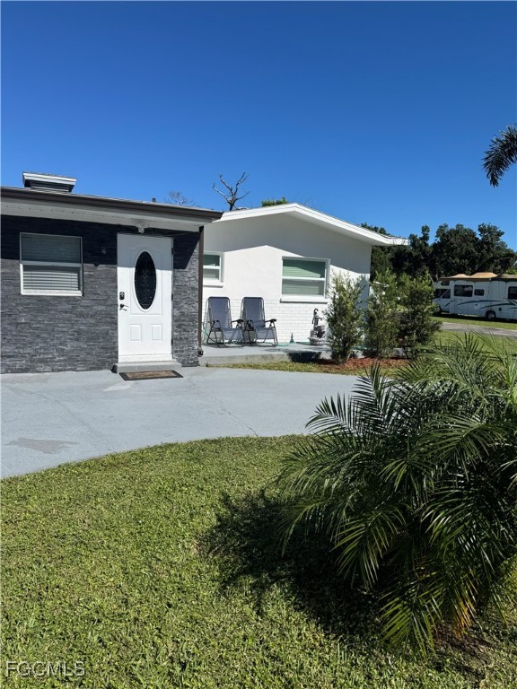 8141 Cleaves Road North Fort Myers, FL 33903 - Photo 34 of 37 a front view of a house with garden