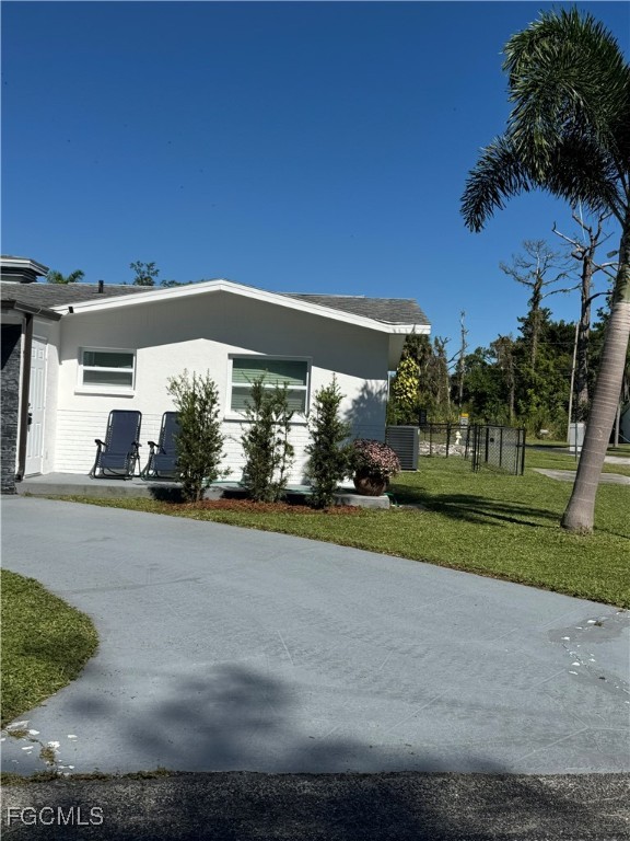 8141 Cleaves Road North Fort Myers, FL 33903 - Photo 35 of 37 a front view of a house with a yard and garage
