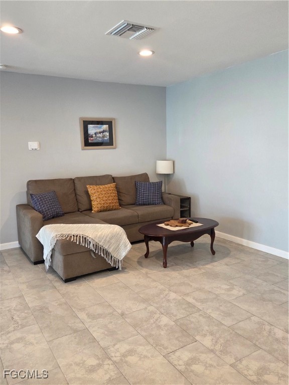 8141 Cleaves Road North Fort Myers, FL 33903 - Photo 6 of 37 a living room with a couch and a night stand