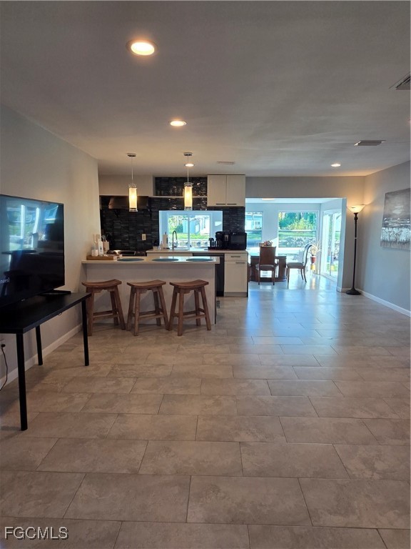 8141 Cleaves Road North Fort Myers, FL 33903 - Photo 8 of 37 a living room with furniture and a flat screen tv