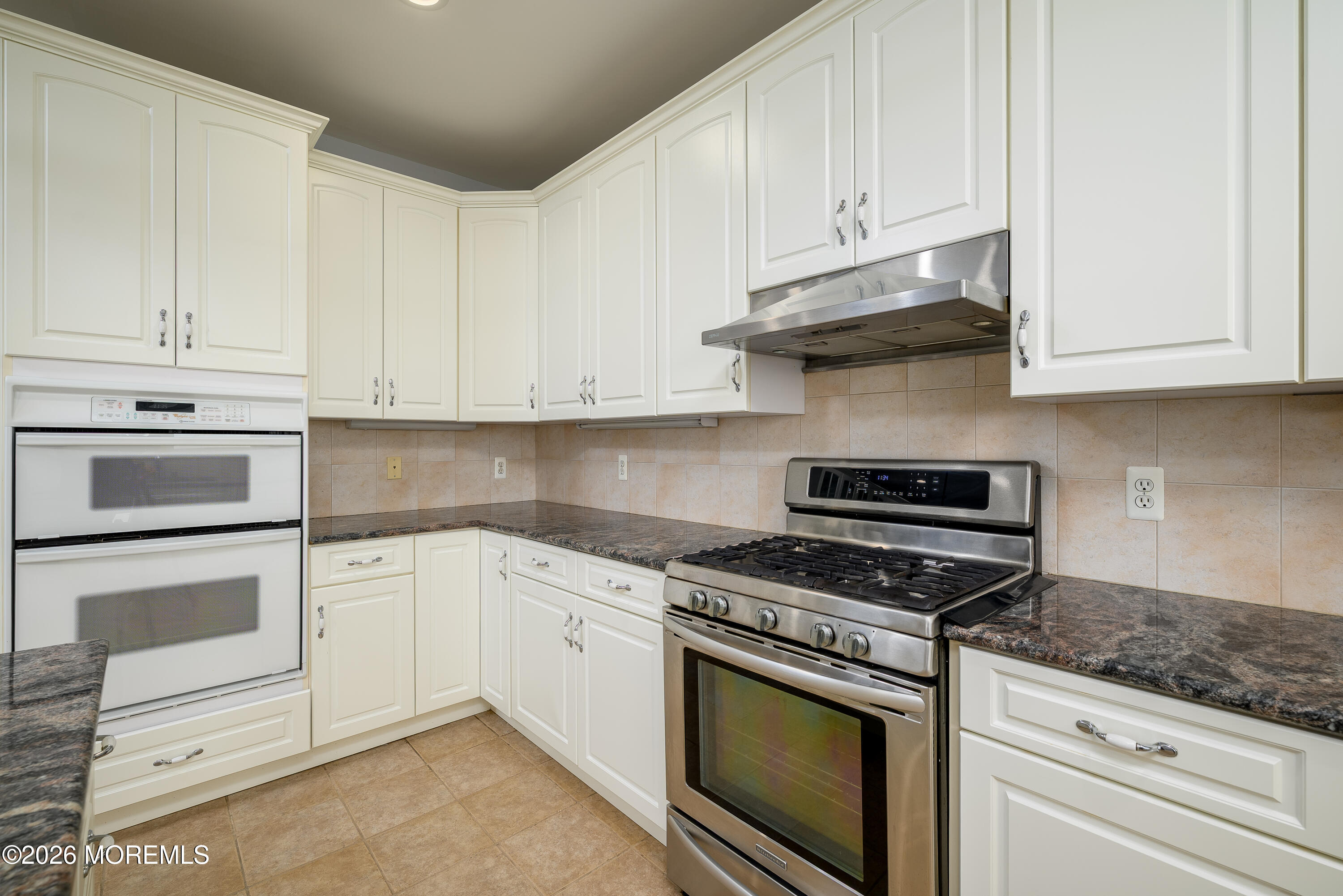 805 Front Street Union Beach, NJ 07735 - Photo 12 of 65 a kitchen with granite countertop white cabinets and appliances