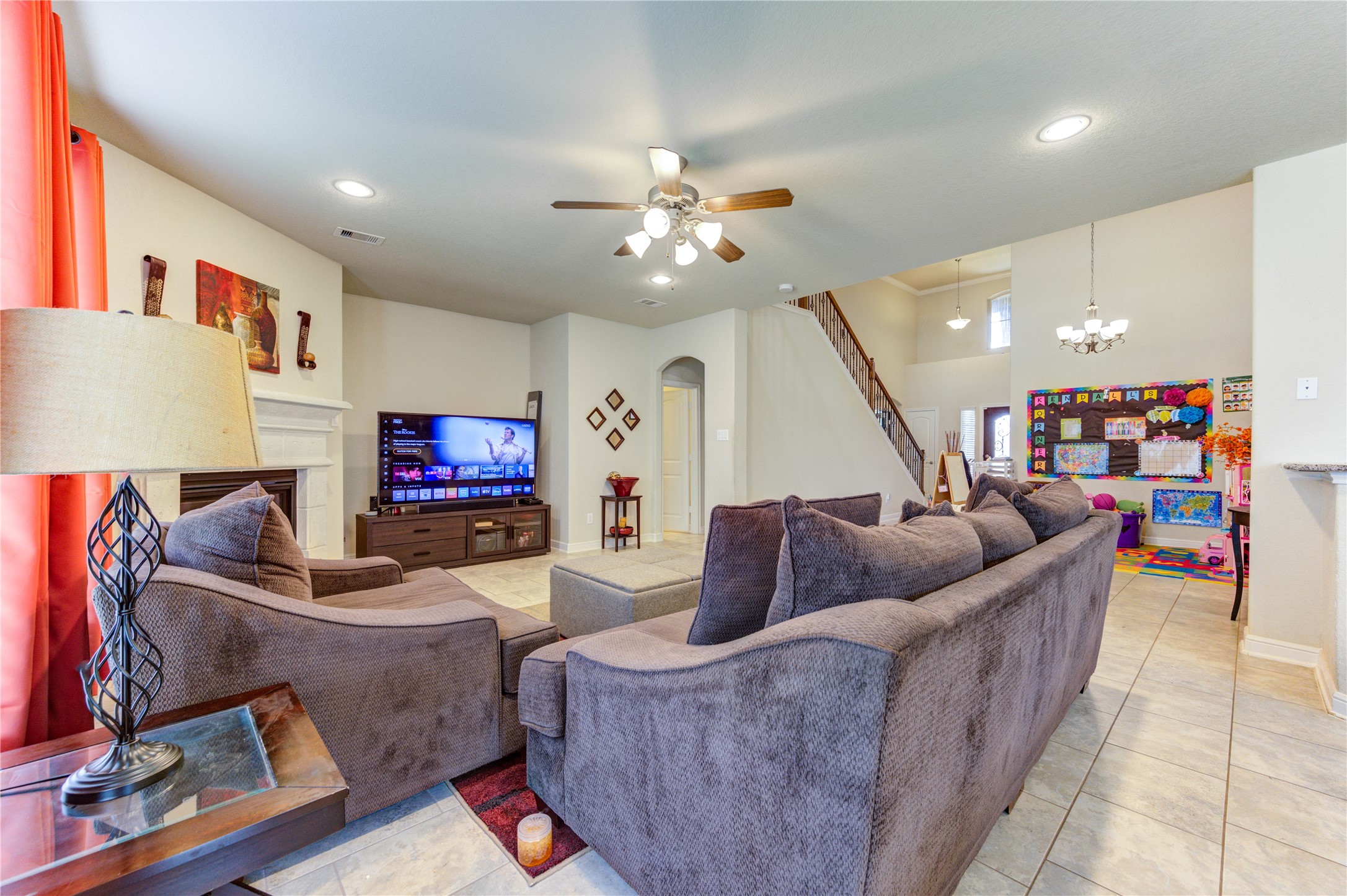 24511 Stratton Creek Drive Spring, TX 77373 - Photo 9 of 27 This welcoming first-floor living area offers the perfect balance of comfort and function, with an open layout, elegant tile flooring, a gas fireplace, and easy access to the breakfast room and kitchen.