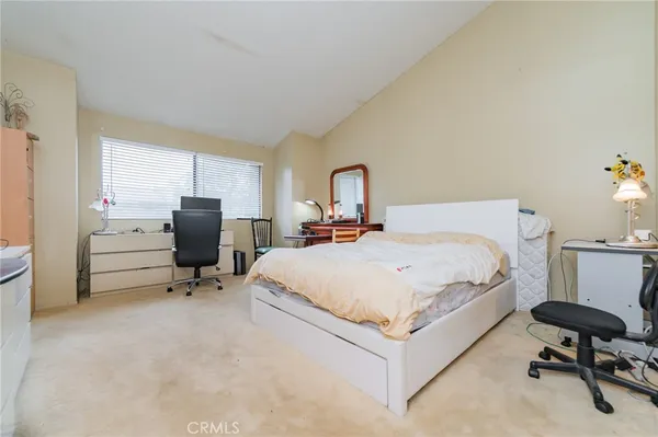 a bedroom with bed and a chair