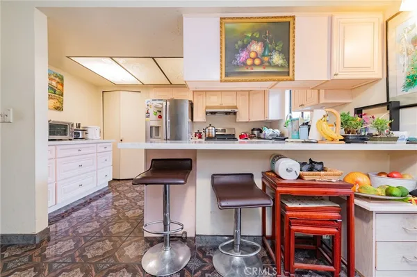 a kitchen with stainless steel appliances a stove a sink and a refrigerator
