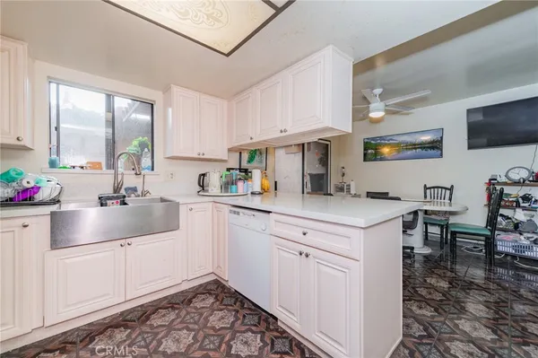 a kitchen with a sink cabinets and window
