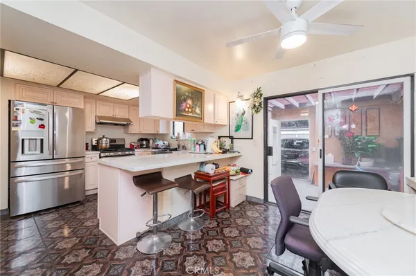 a kitchen with stainless steel appliances kitchen island granite countertop a sink and cabinets
